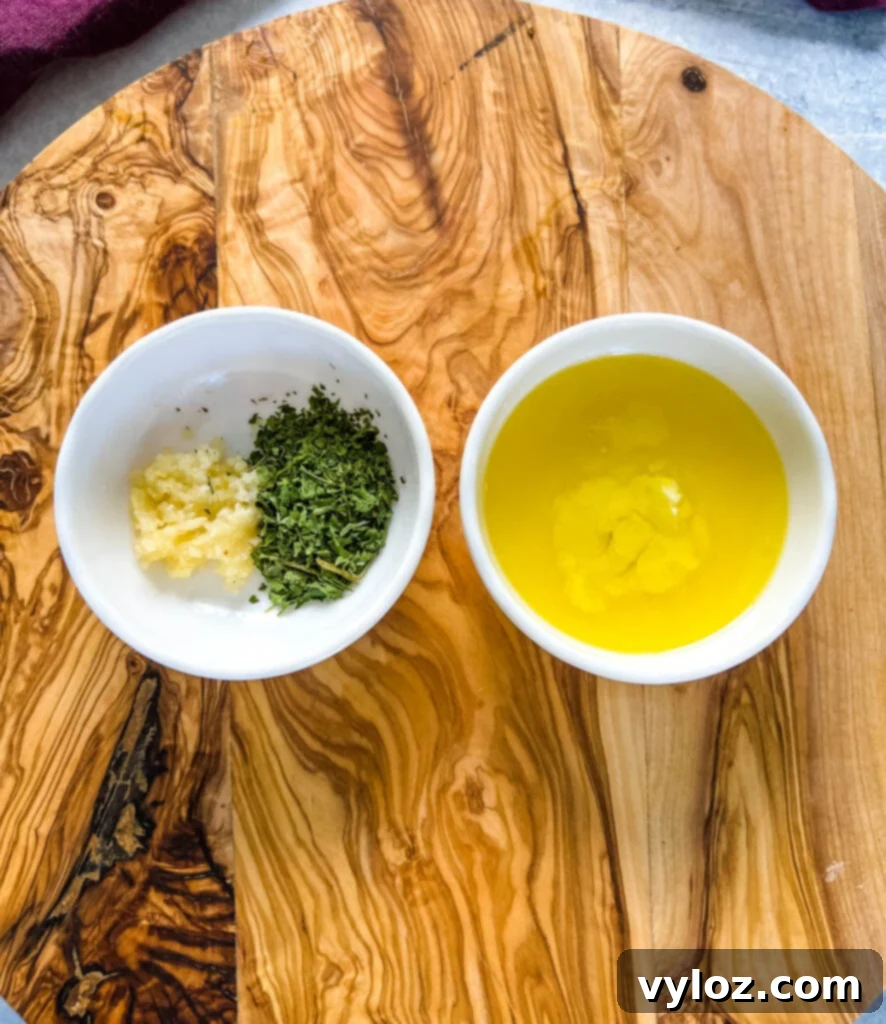 butter, olive oil, garlic, and parsley in white bowls
