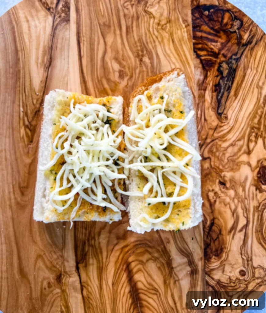 garlic bread with cheese on a cutting board