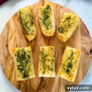 air fryer garlic bread on a wooden cutting board