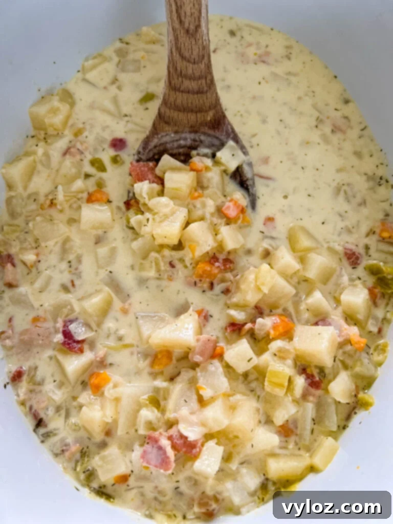 Ultimate Slow Cooker Loaded Potato and Bacon Soup 10 A Crockpot slow cooker filled with hearty, loaded potato soup, ready for garnishing and serving.