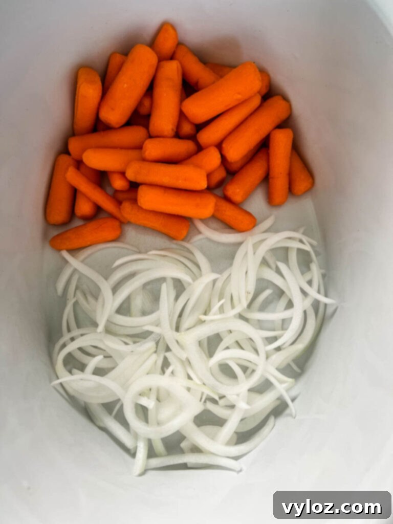 carrots and onions in a Crockpot slow cooker