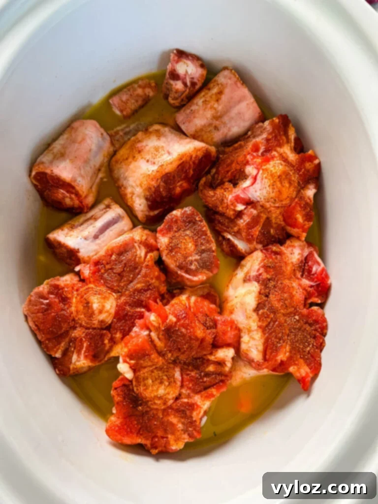 raw oxtails in a Crockpot slow cooker