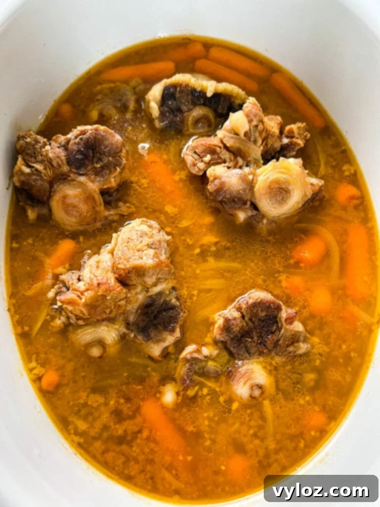 cooked oxtails in a Crockpot slow cooker