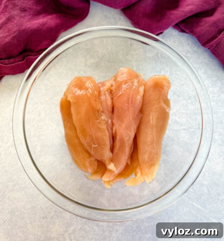 raw chicken tenderloins in a glass bowl