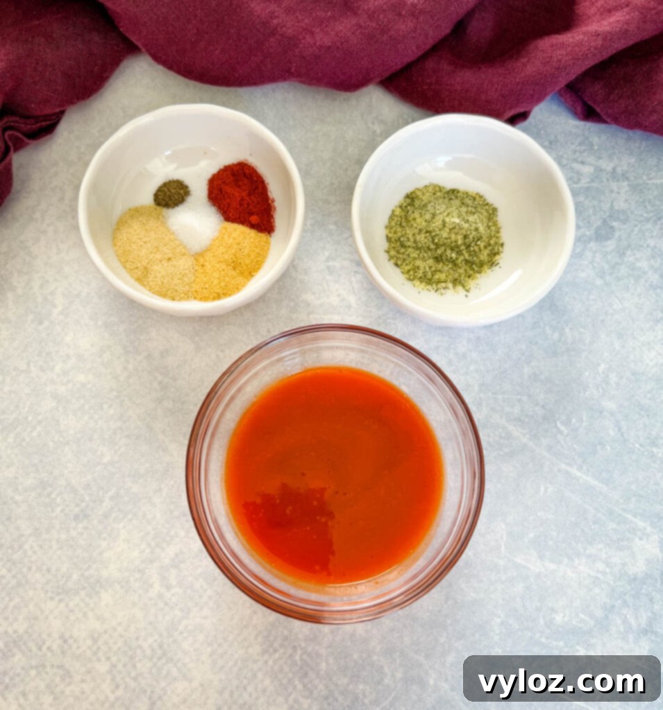 buffalo sauce and spices in separate white bowls