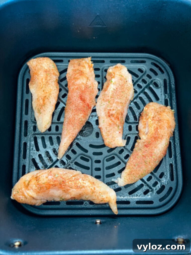 raw chicken tenders in an air fryer