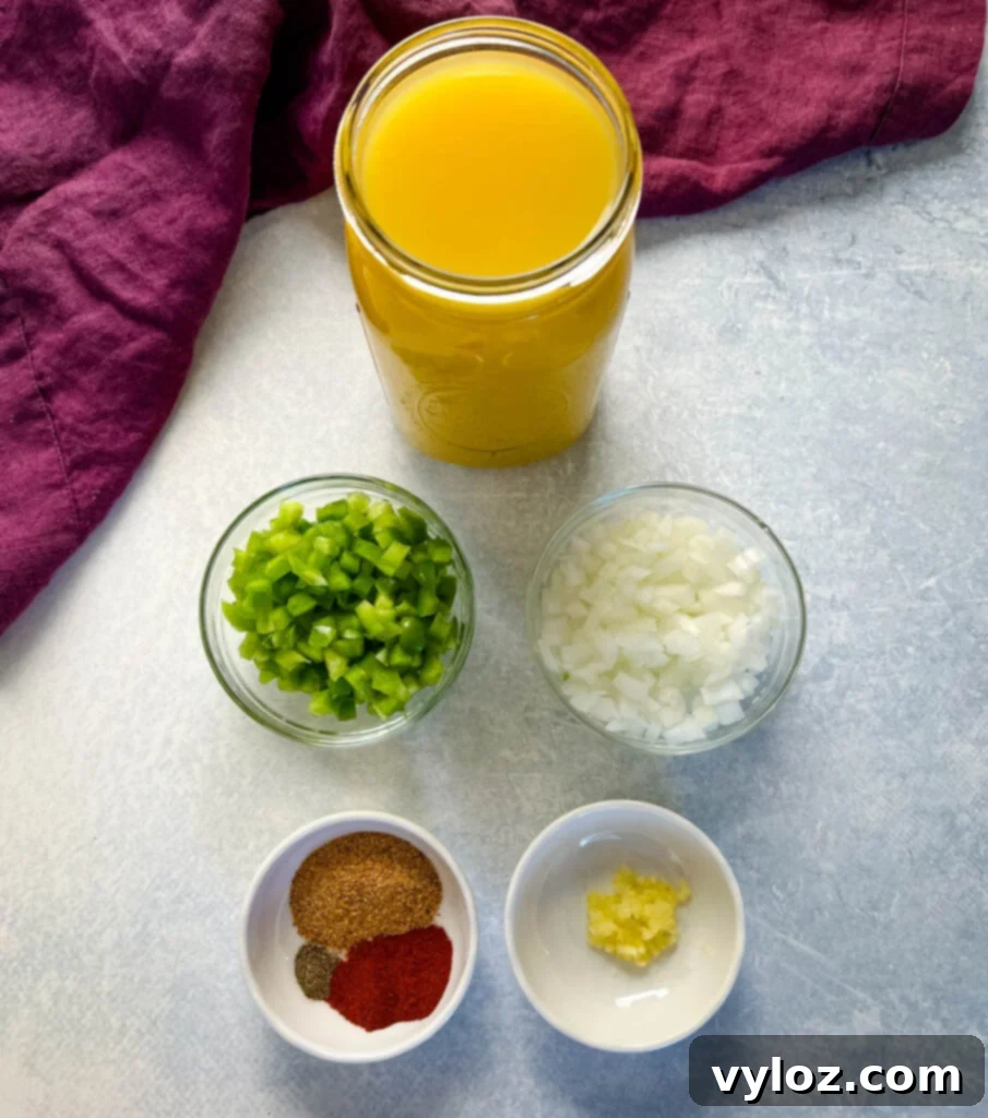 Fresh ingredients laid out: bowls of rich beef broth, vibrant green peppers, sliced onions, a selection of aromatic spices, and minced garlic, ready for cooking oxtail