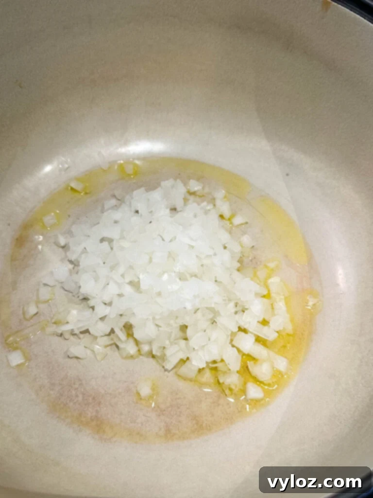 Onions and olive oil sautéing in a Dutch oven to build flavor