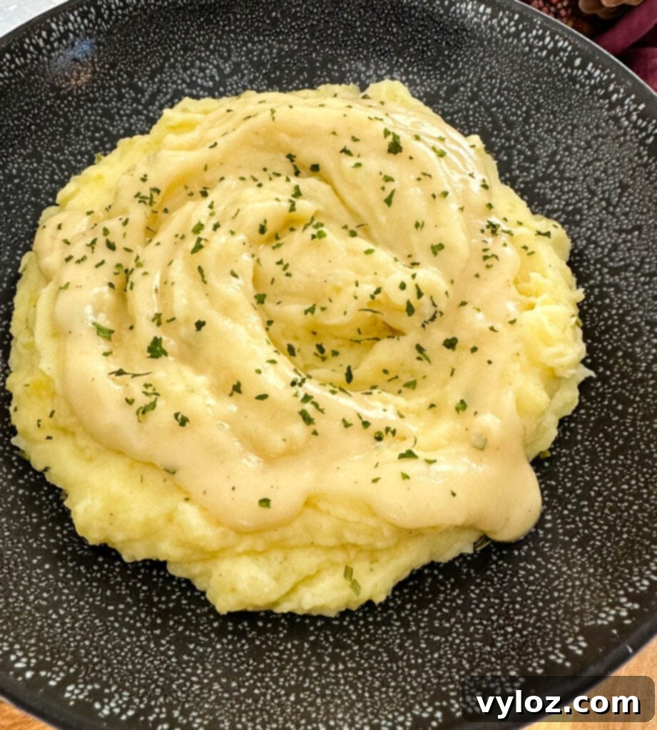Velvety Buttermilk Mash 2 Southern buttermilk mashed potatoes in a black bowl