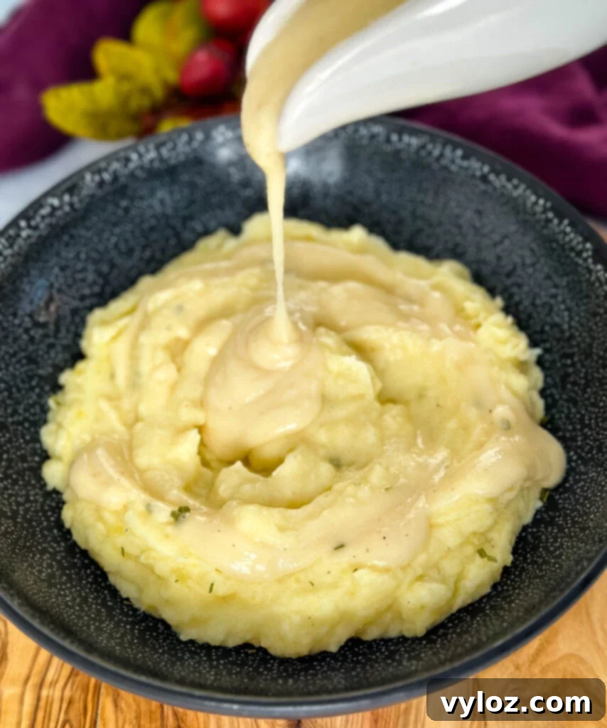 Velvety Buttermilk Mash 12 gravy drizzled over buttermilk mashed potatoes in a bowl