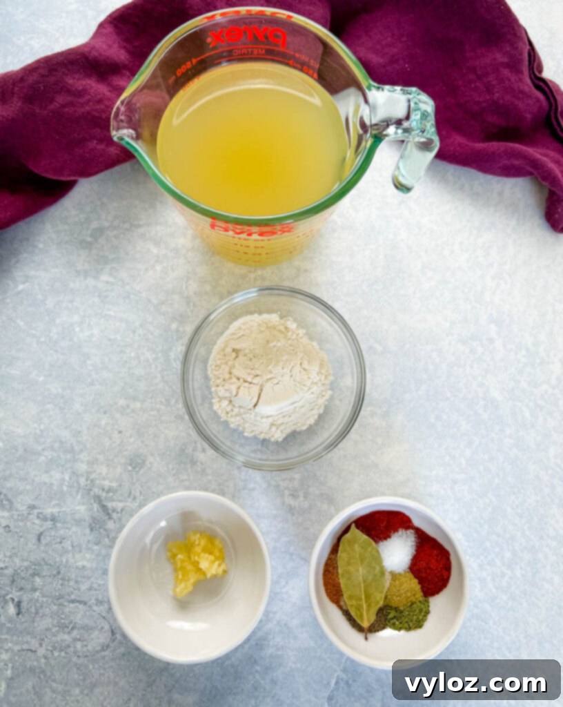Cajun Ground Beef and Rice 4 Broth, flour, various spices, and minced garlic in separate bowls, prepared for cooking.