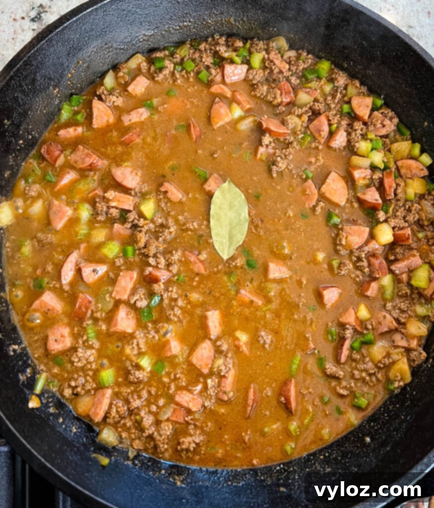 Cajun Ground Beef and Rice 10 Ground beef, sausage, and the Holy Trinity vegetables mixed in a cast iron skillet.