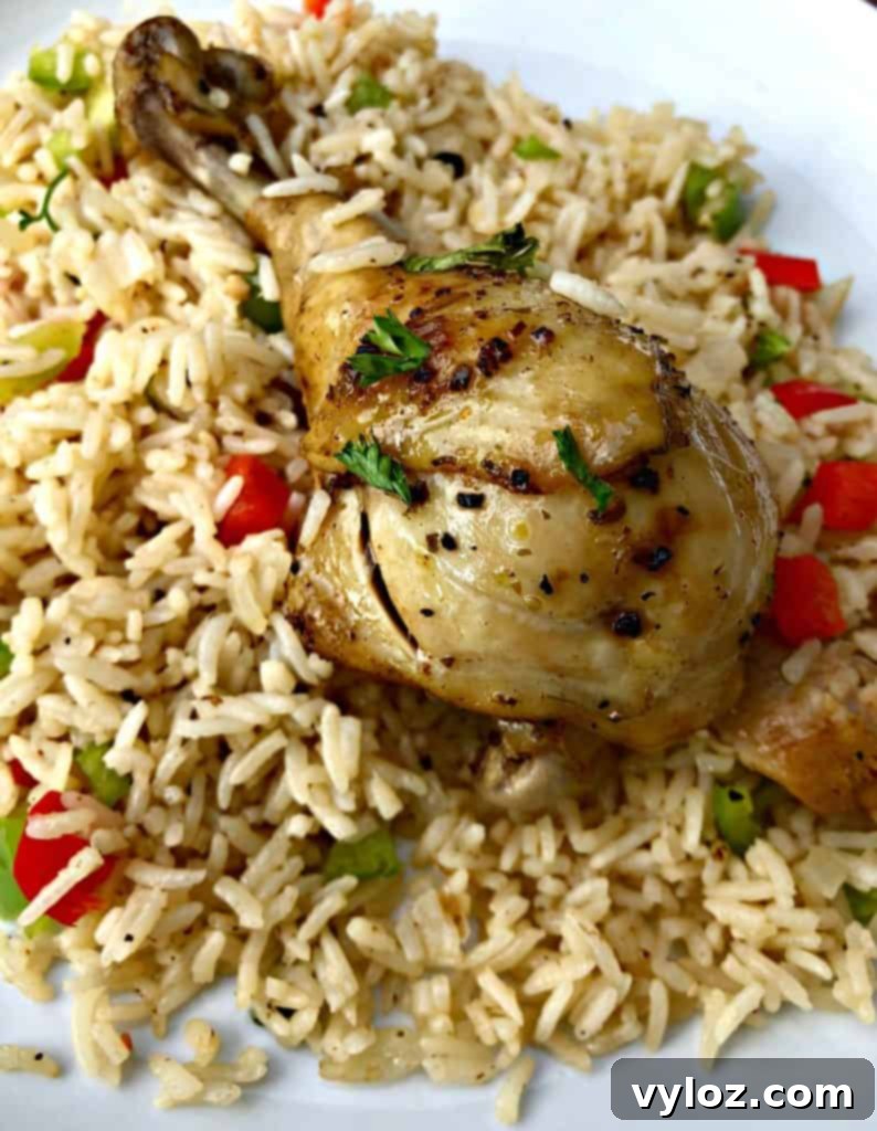 Instant Pot Arroz con Pollo Drumsticks 9 A generous portion of Arroz con Pollo in a white bowl, highlighting the rich colors and textures of the chicken and seasoned rice.