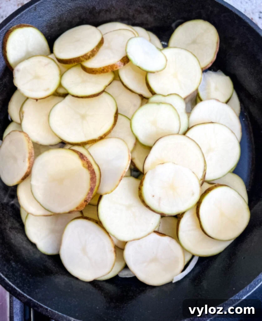 potatoes, onions, and green pepper in a cast iron skillet