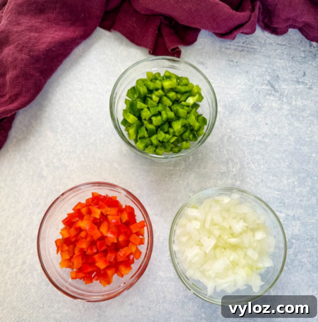 Ultimate Italian Sausage Spaghetti 3 chopped green peppers, red peppers, and onions in separate glass bowls