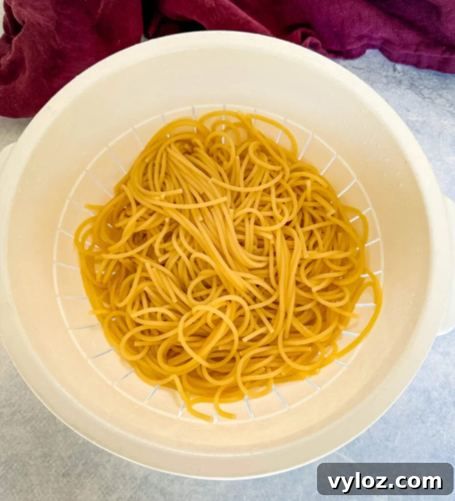 Ultimate Italian Sausage Spaghetti 5 cooked pasta in a colander