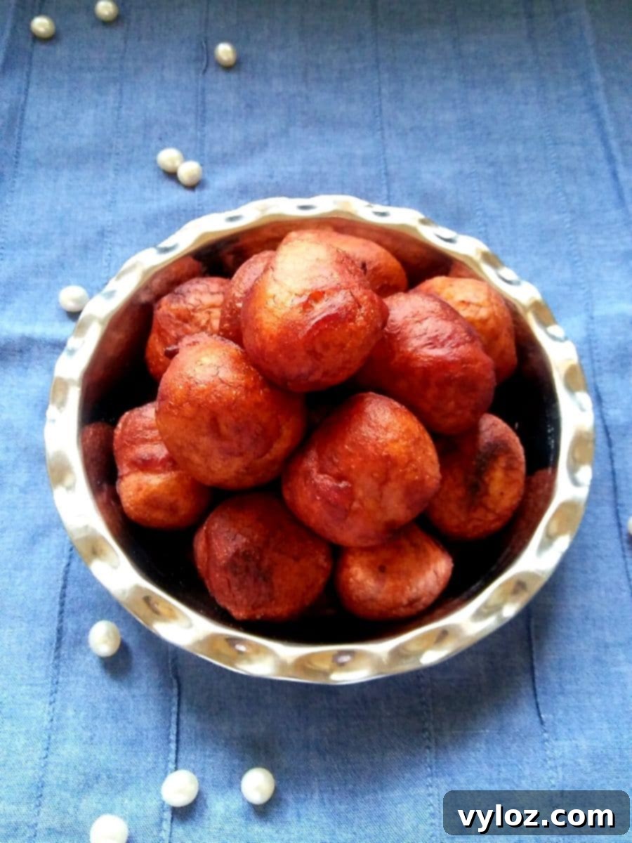 Golden brown gulgula fritters served on a plate