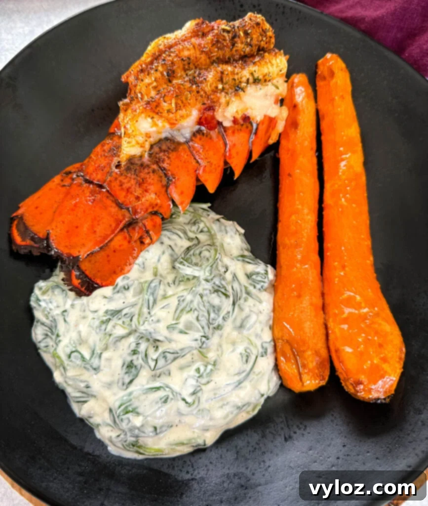 Classic Southern Creamed Spinach, Fresh or Frozen 11 lobster, carrots, and creamed spinach on a black plate