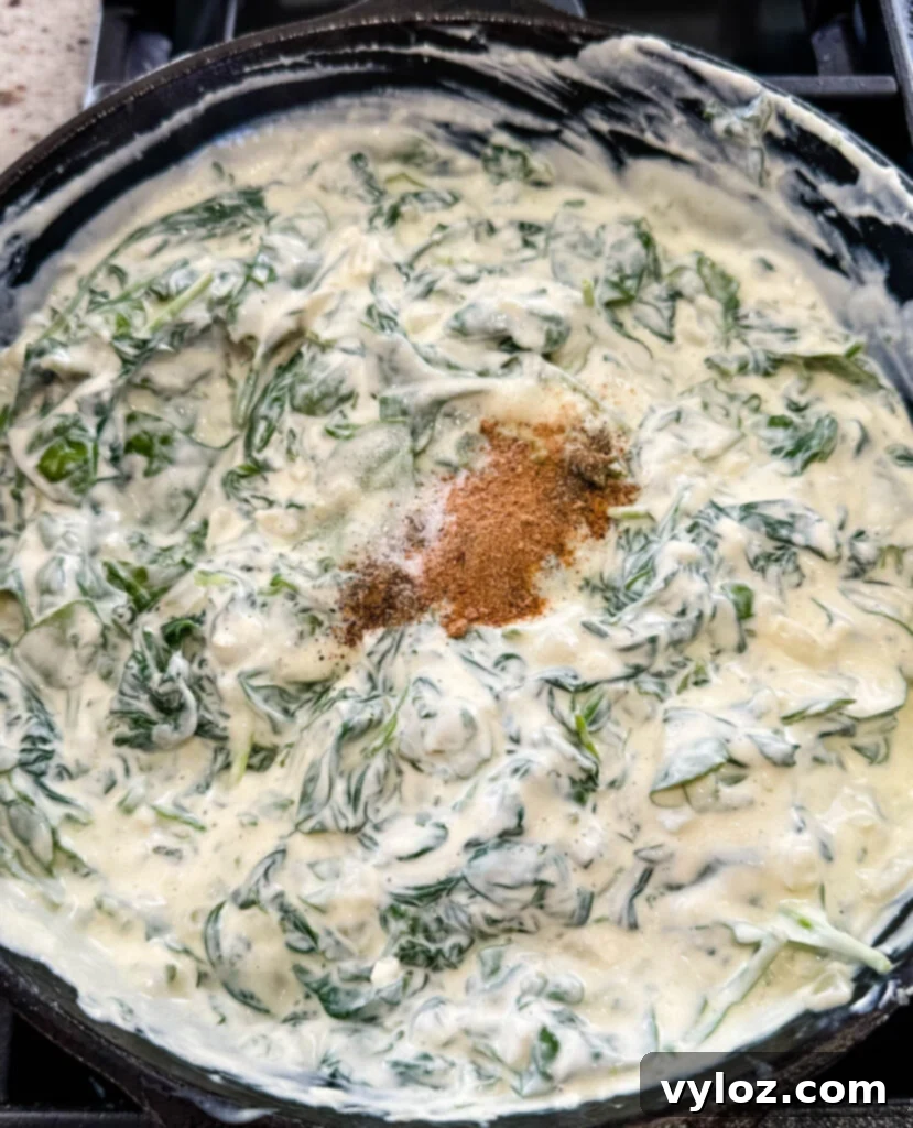 Classic Southern Creamed Spinach, Fresh or Frozen 7 steakhouse creamed spinach in a cast iron skillet with nutmeg and spices