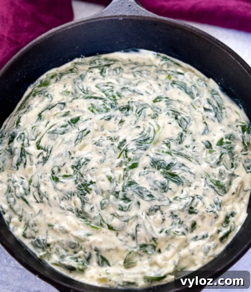 Classic Southern Creamed Spinach, Fresh or Frozen 8 steakhouse creamed spinach in a cast iron skillet