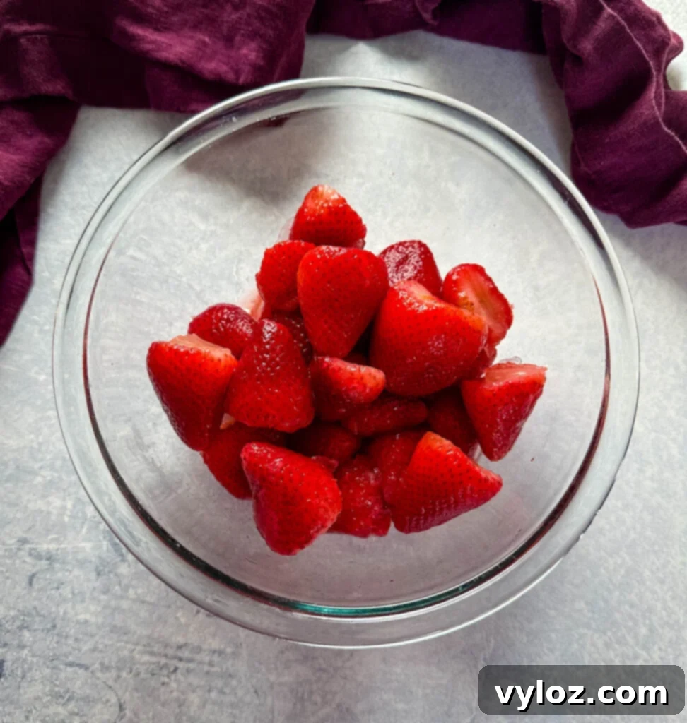 The Ultimate Hennessy Margarita 4 strawberries in a glass bowl