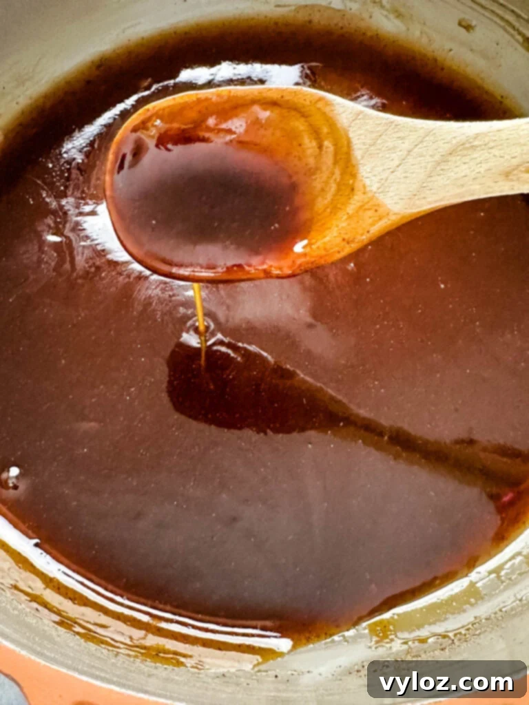 Homemade honey brown sugar ham glaze simmering in a saucepan