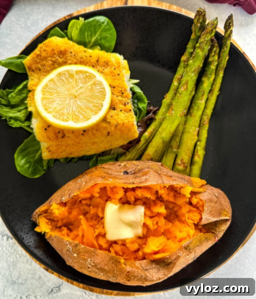Smoked Cod 8 A black plate showcasing smoked cod, smoked sweet potato, and asparagus, a perfect meal.