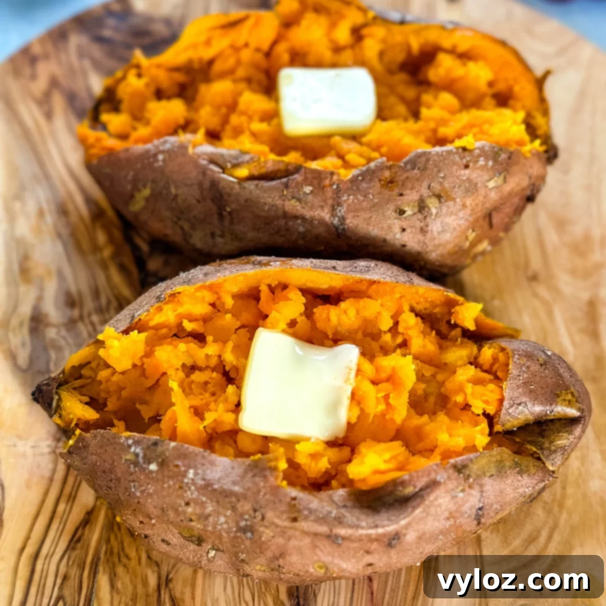 Smoked sweet potatoes in butter on a flat surface, ready to be served.
