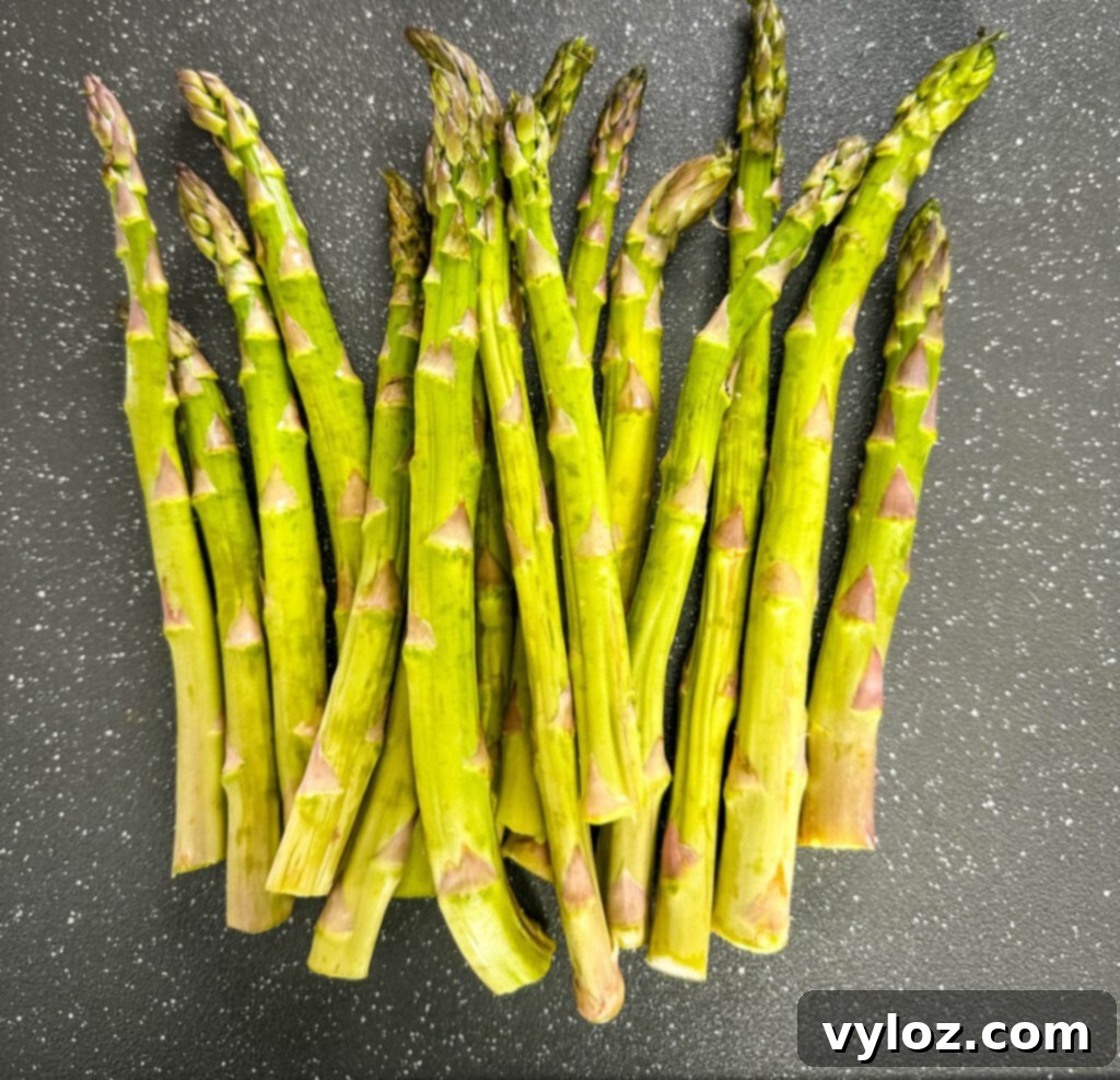 Wood-Kissed Asparagus 3 fresh asparagus on a plate