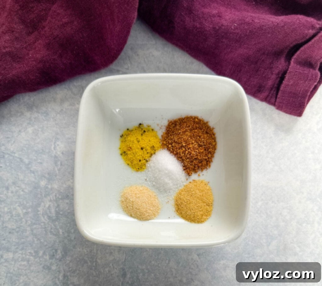 Wood-Kissed Asparagus 4 garlic powder, onion powder, salt, and BBQ rub in a white bowl