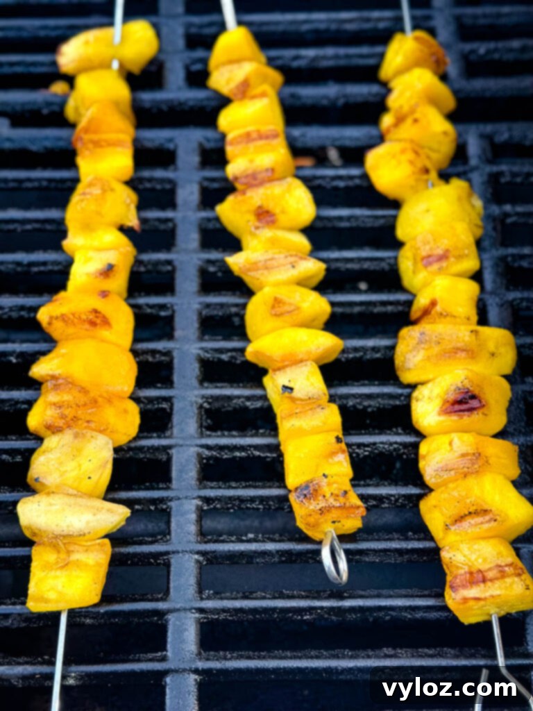 mango on skewers on a grill