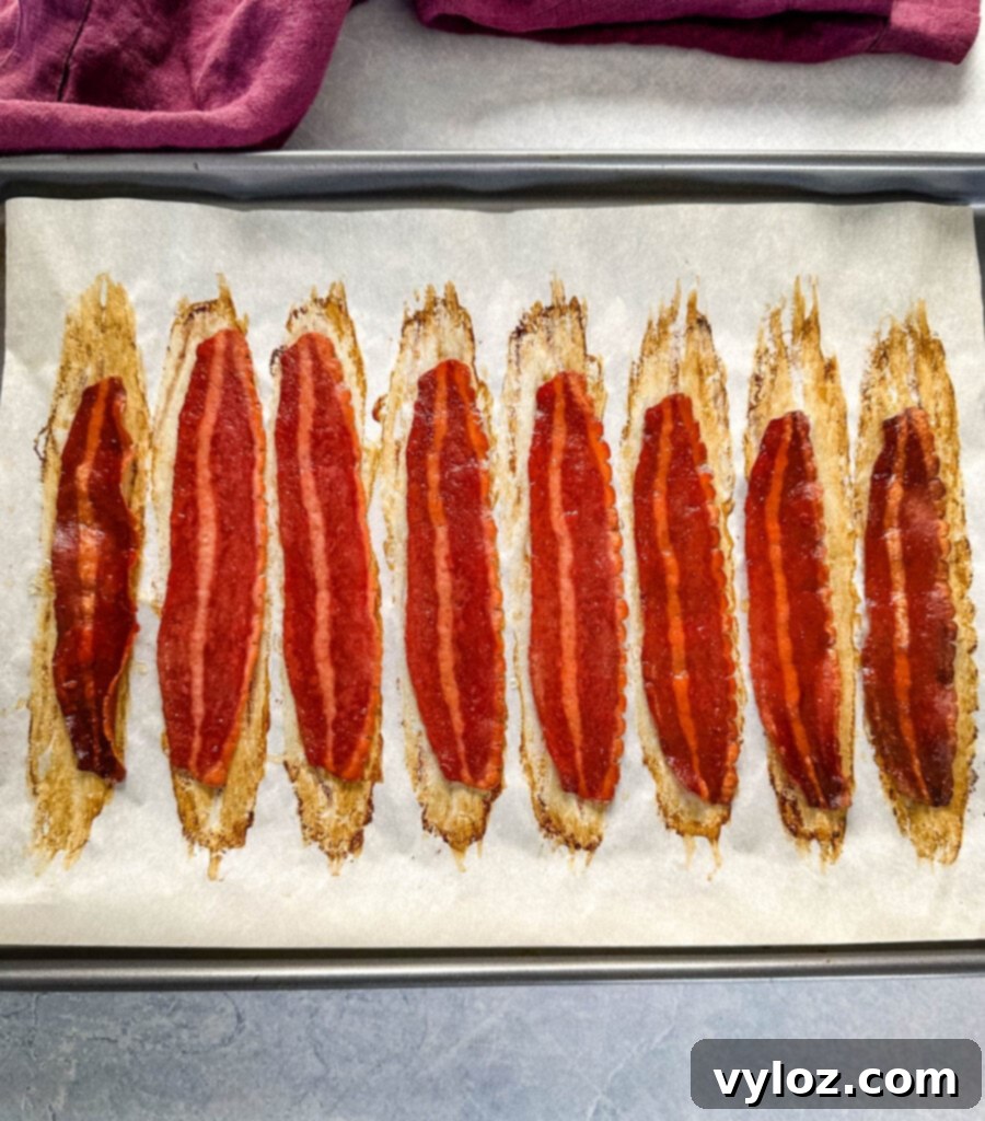 baked turkey bacon on a sheet pan with parchment paper