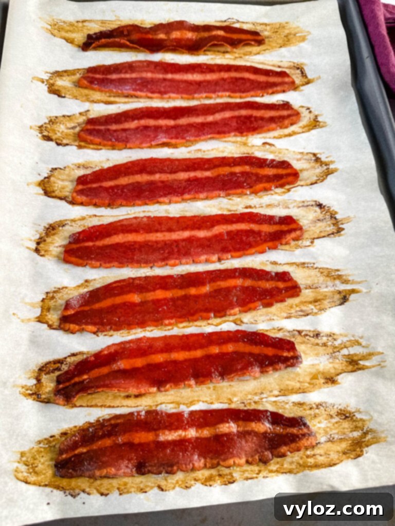baked turkey bacon on a sheet pan with parchment paper