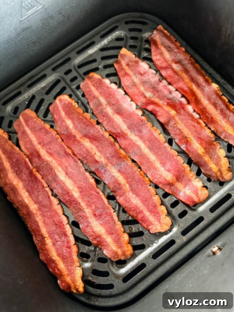 Crispy air fryer turkey bacon cooked to perfection, golden brown and ready to be enjoyed as a meal.