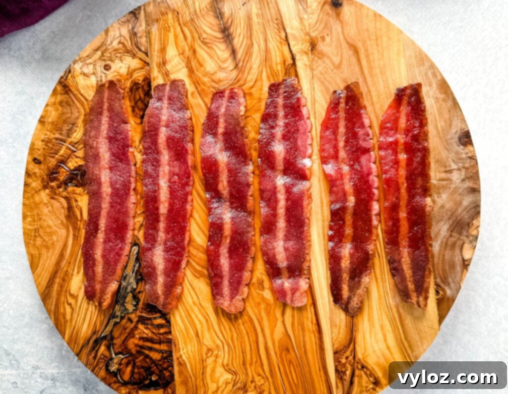 A serving of crispy air fryer turkey bacon on a plate, ready to be enjoyed as part of a healthy meal.