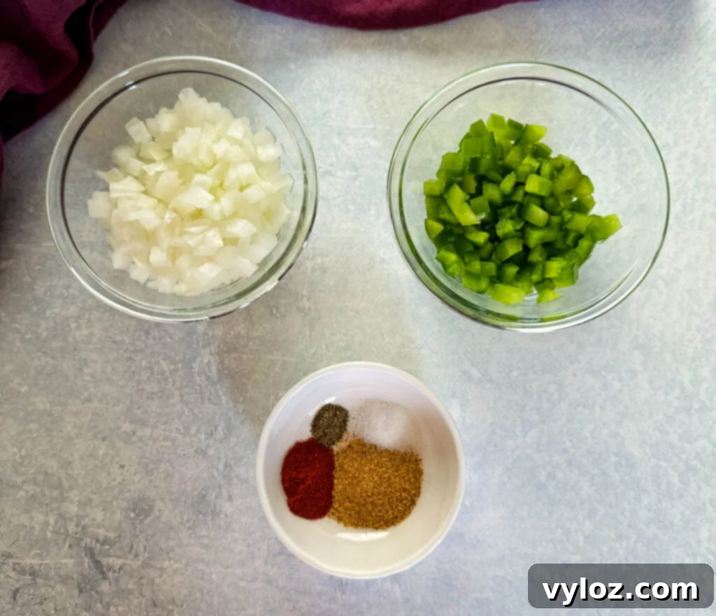 Savory Slow-Cooked Potatoes and Onions 3 Chopped onions, chopped green peppers, and various spices in separate bowls, ready for cooking