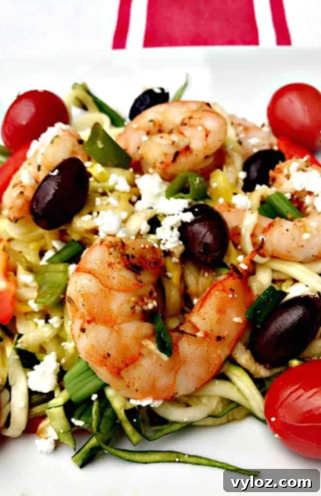 Ingredients for Sheet-Pan Mediterranean Shrimp with Zucchini Noodles, including raw shrimp, vegetables, and seasoning