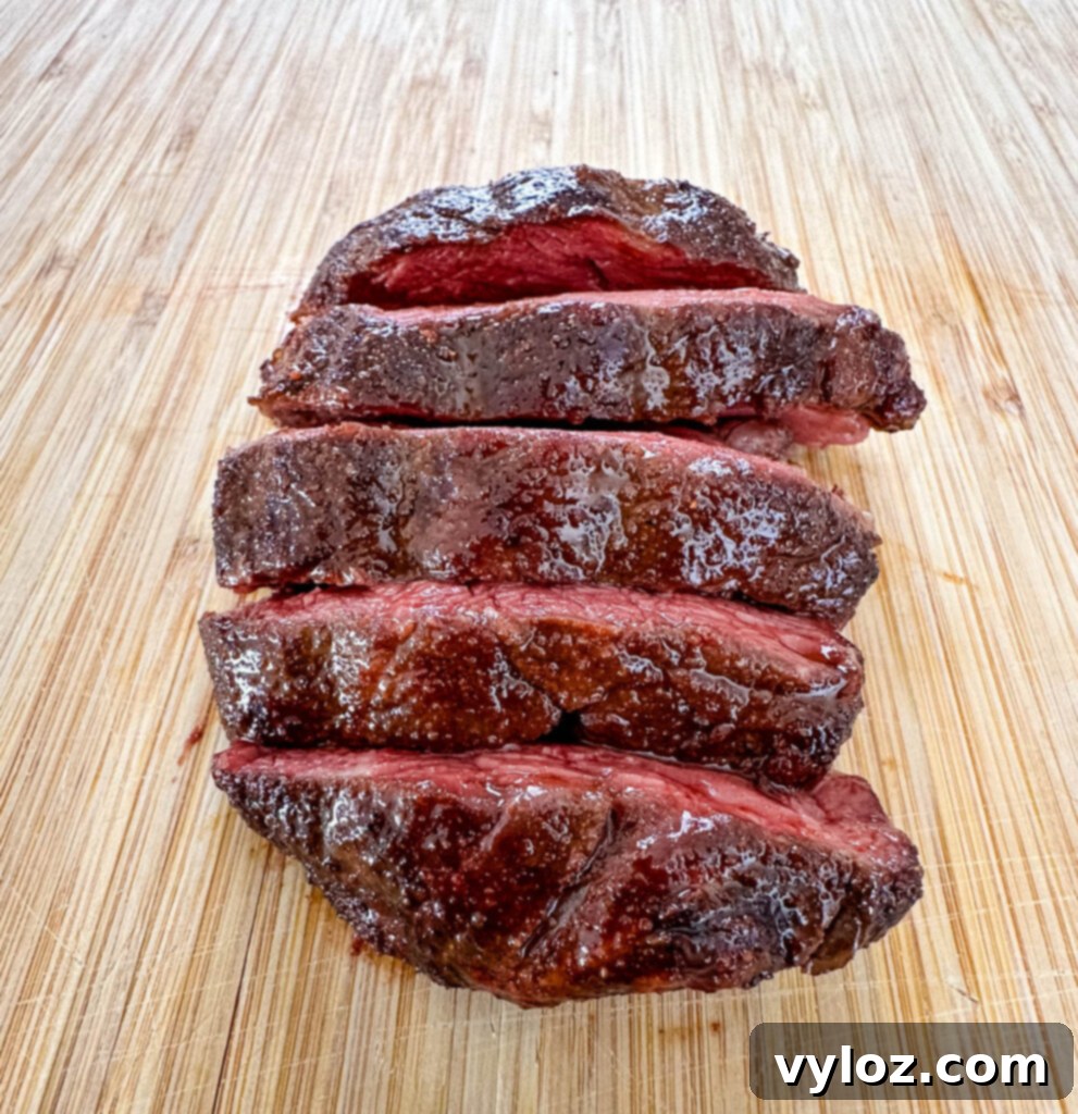 sliced smoked filet mignon on a cutting board