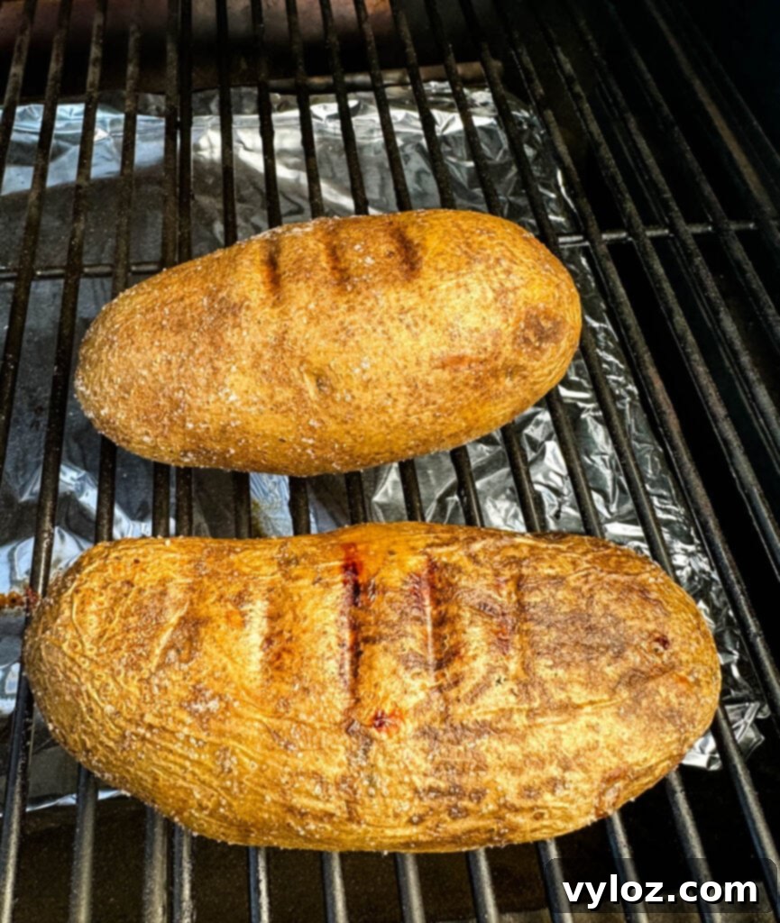 Traeger Smoked Baked Potatoes 5 baked potatoes on a Traeger pellet grill