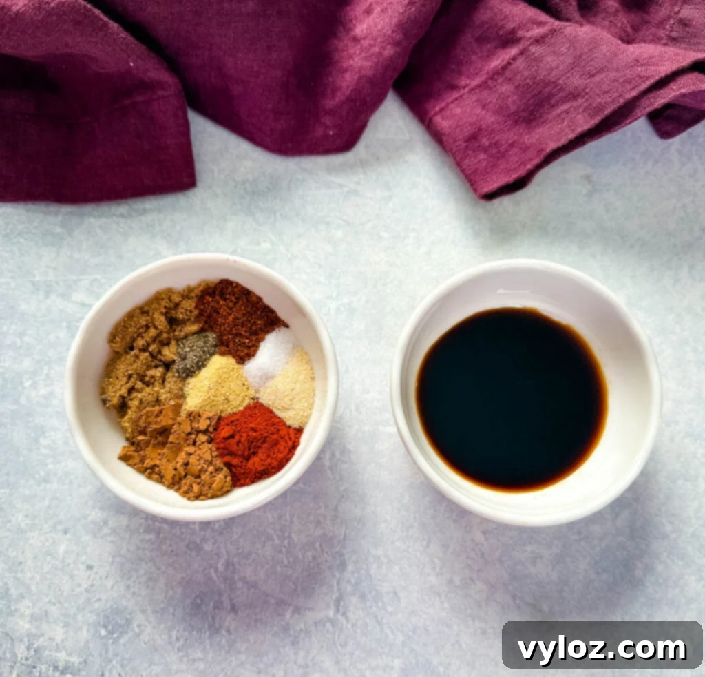 Traeger Wood Fired Ribeye 3 Homemade steak rub ingredients including unsweetened cocoa powder and various spices in a white bowl, along with a small bowl of soy sauce.