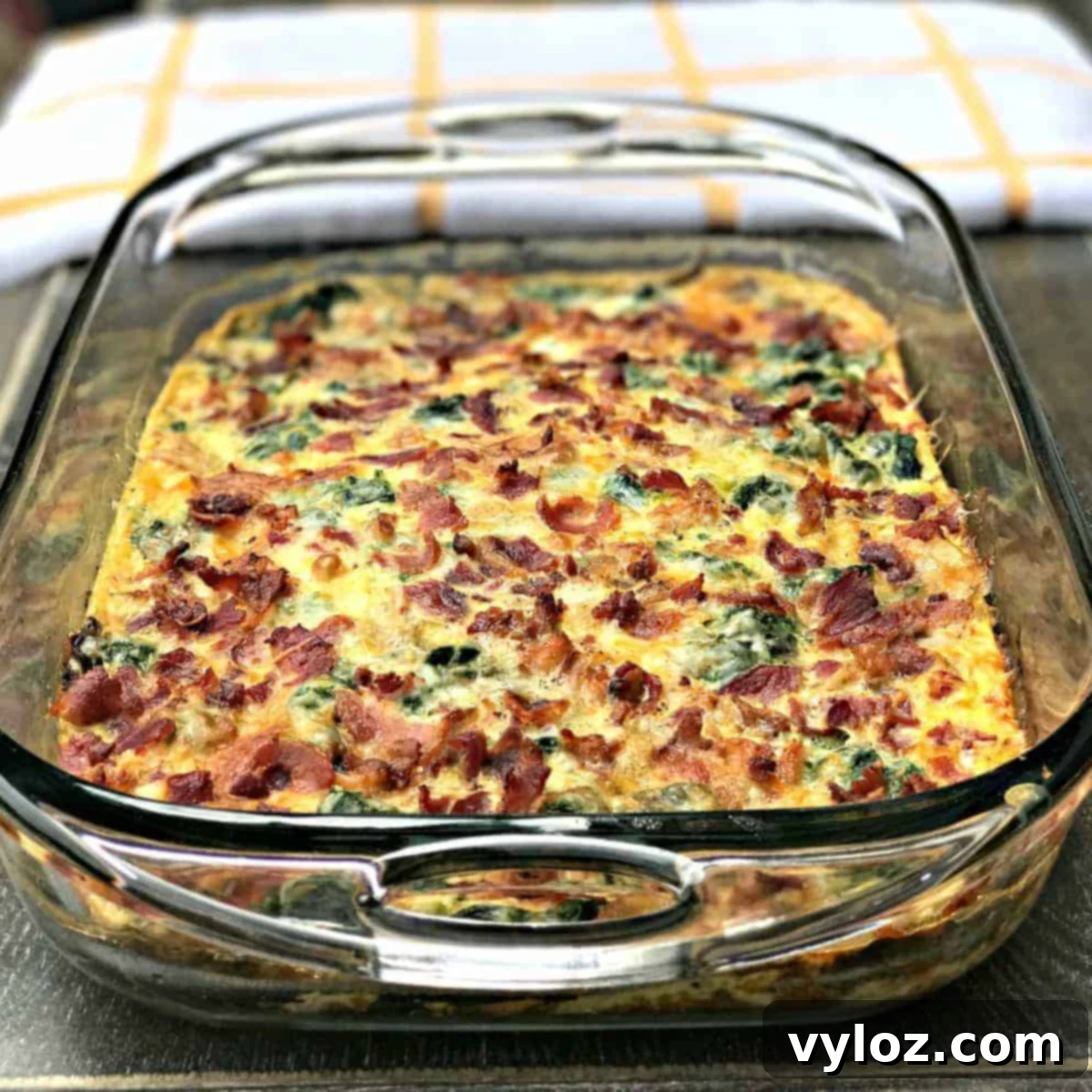Bacon, Egg, and Spinach Breakfast Casserole in a glass baking dish, ready to be served