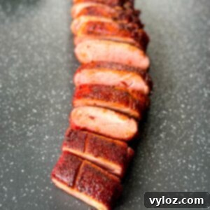 sliced smoked pork tenderloin on a flat surface