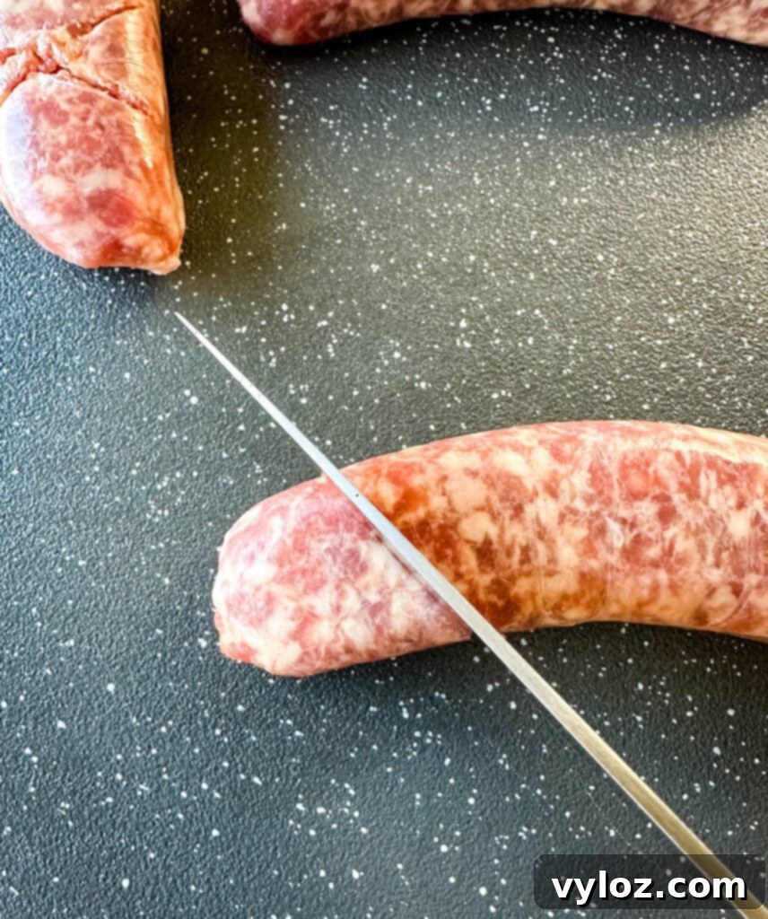 The Perfect Traeger Smoked Brats 4 brat scored on a sheet pan