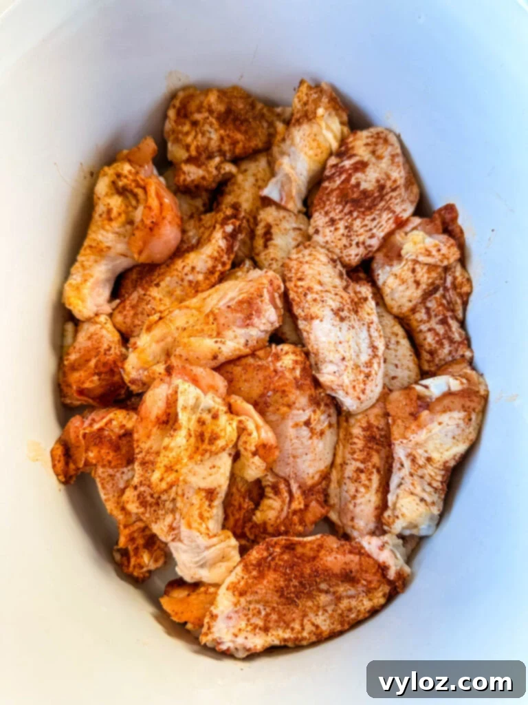 raw seasoned chicken wings in a Crockpot slow cooker