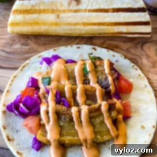 pork belly taco with seared flour tortilla and spicy Chipotle sauce and pico de gallo