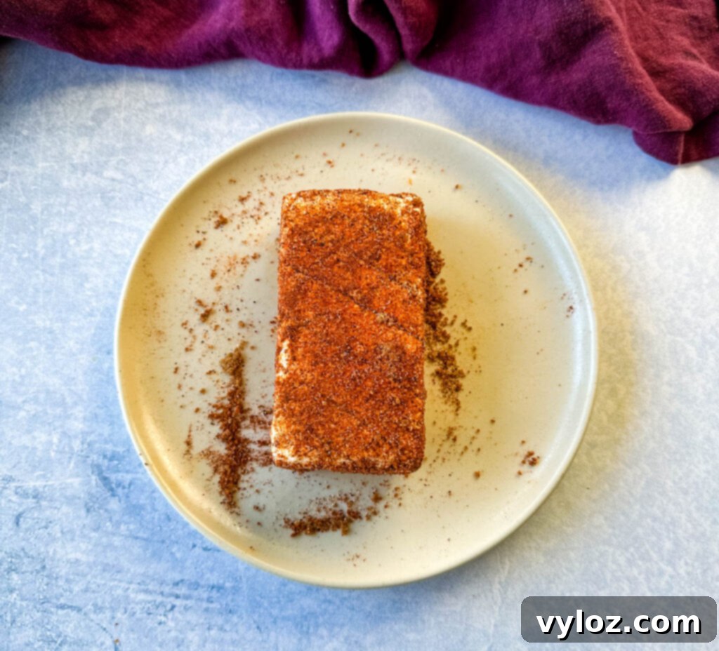 cream cheese rubbed in a homemade BBQ rub seasoning on a plate