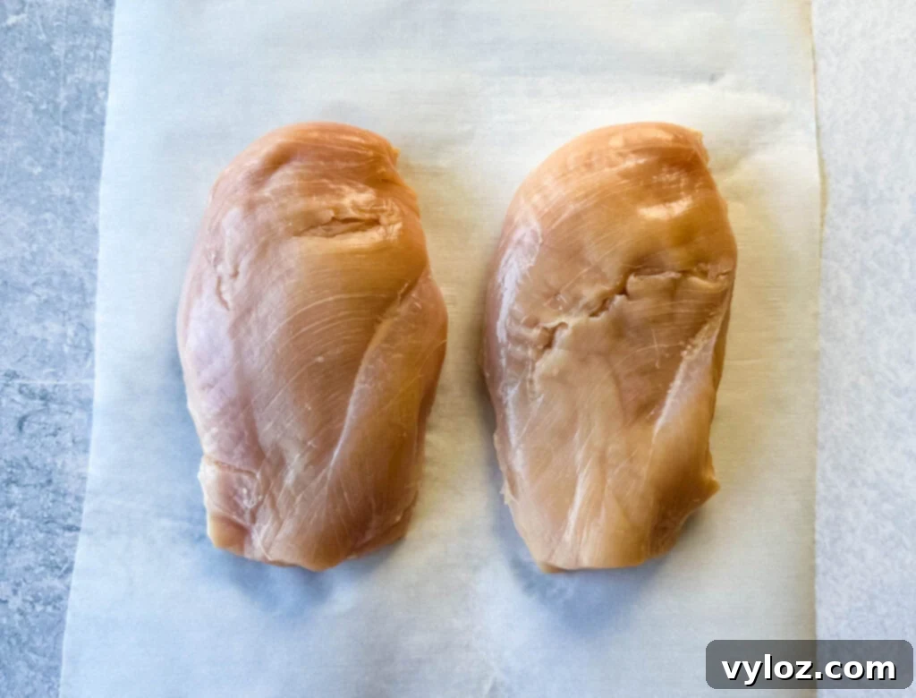 Blackened Chicken 3 raw chicken breasts on parchment paper