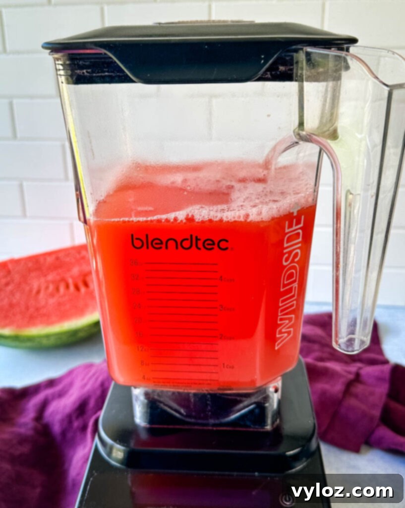 Freshly blended watermelon lemonade in a high-powered blender, ready to be poured and enjoyed.