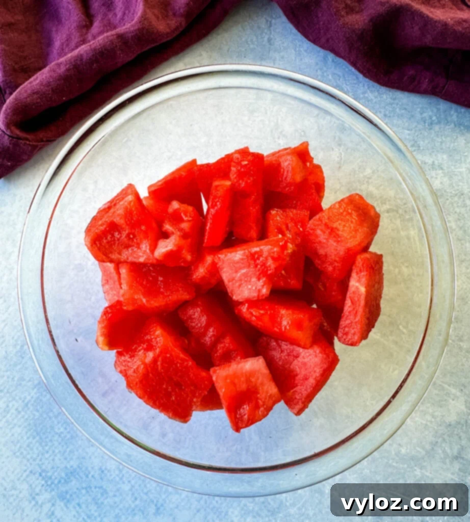 Watermelon Slush Margarita 3 Fresh watermelon chunks in a clear glass bowl, ready for blending