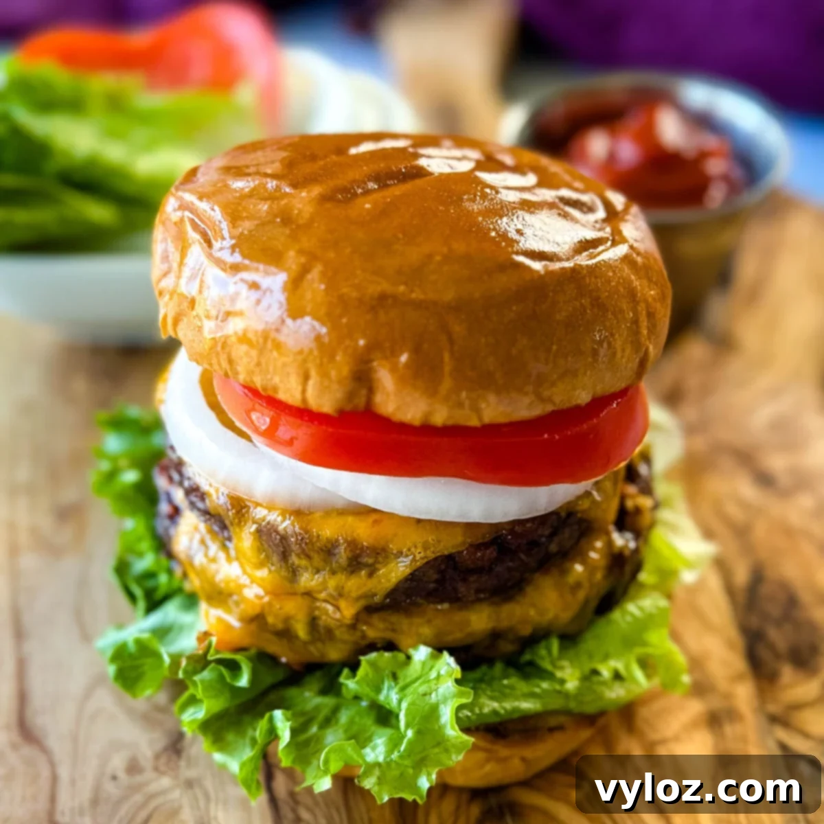 Traeger smoked burger on a bun with cheese, lettuce, tomato, and onions